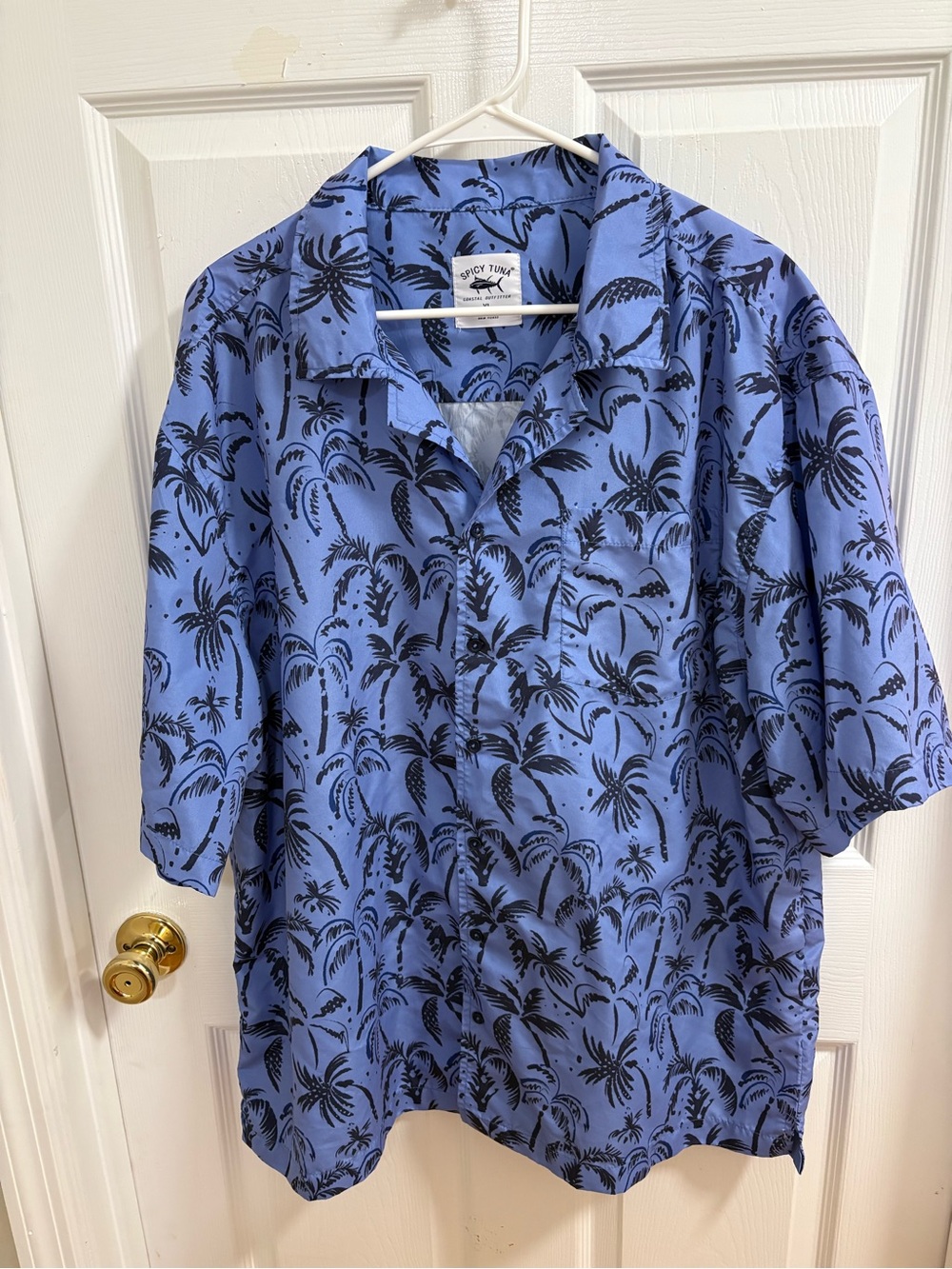 blue Spicy Tuna button-up shirt features a prominent black palm tree pattern.